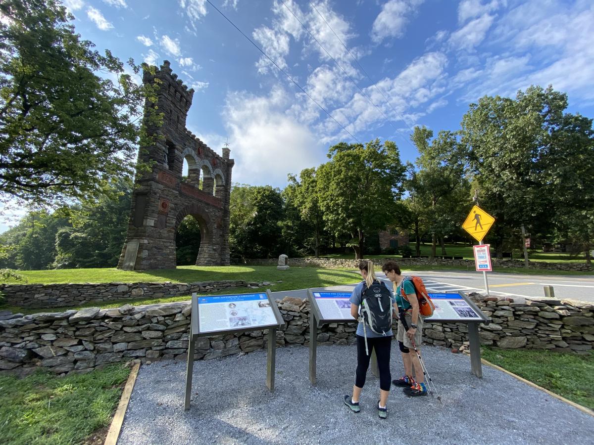 Two women reading through information about the War Correspondence Arch