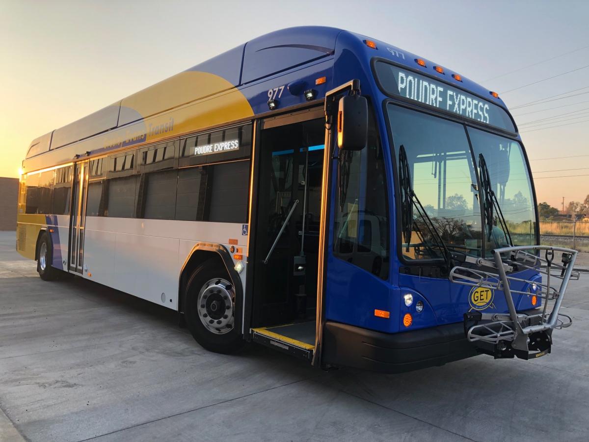 Poudre Express Bus with the sun rising from the left.