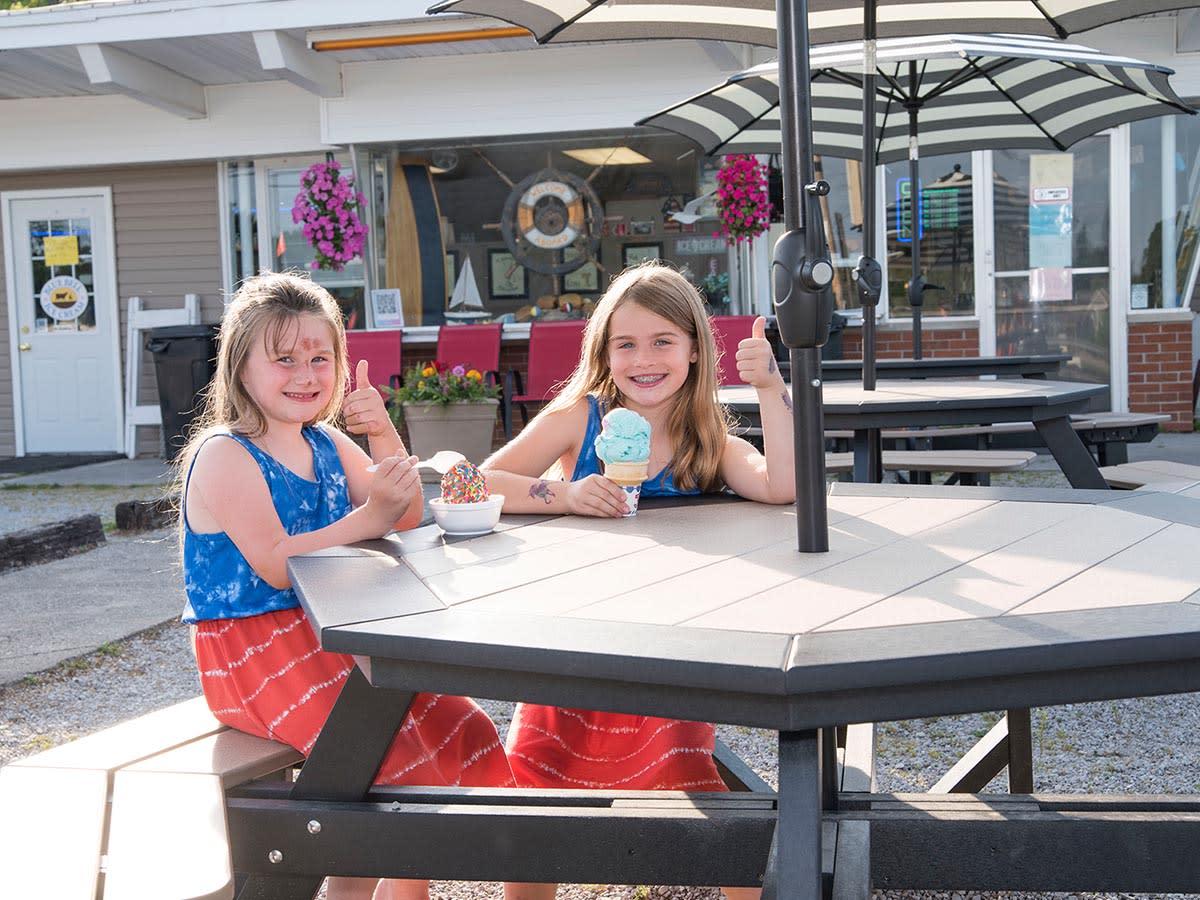 Two girls eating ice cream outside of Captn Pete's Dairy Dock in Steuben County.