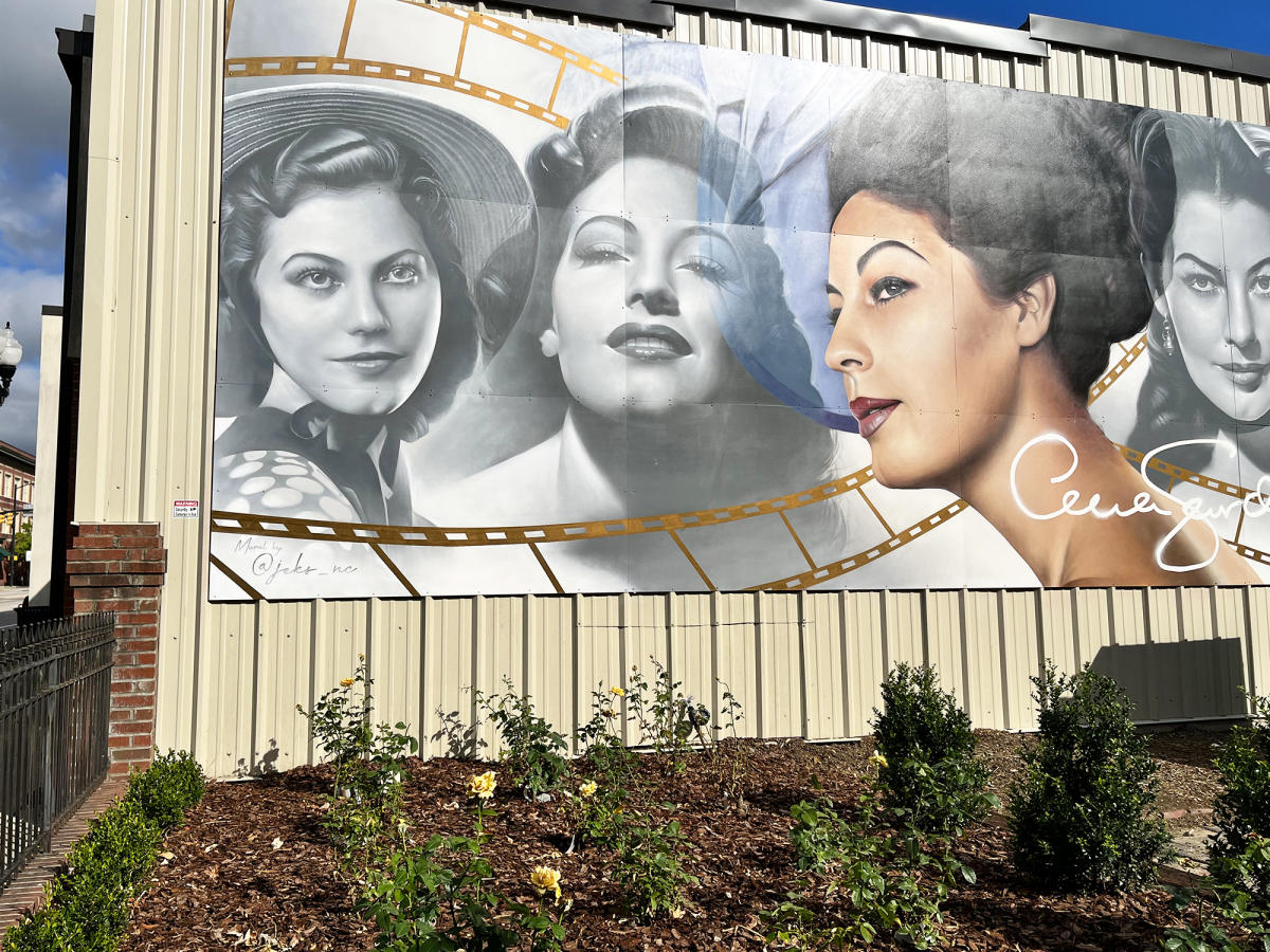 Ava Gardner Museum Mural with yellow roses planted beneath