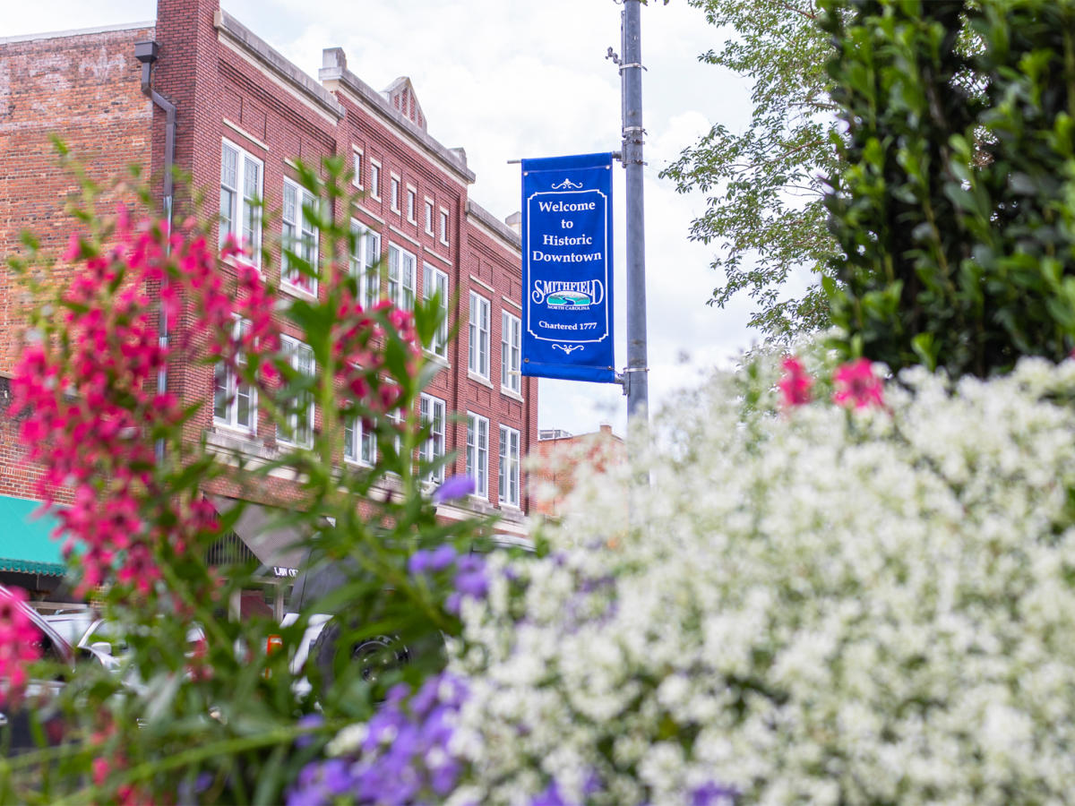 Downtown Smithfield street sign seen through flowers