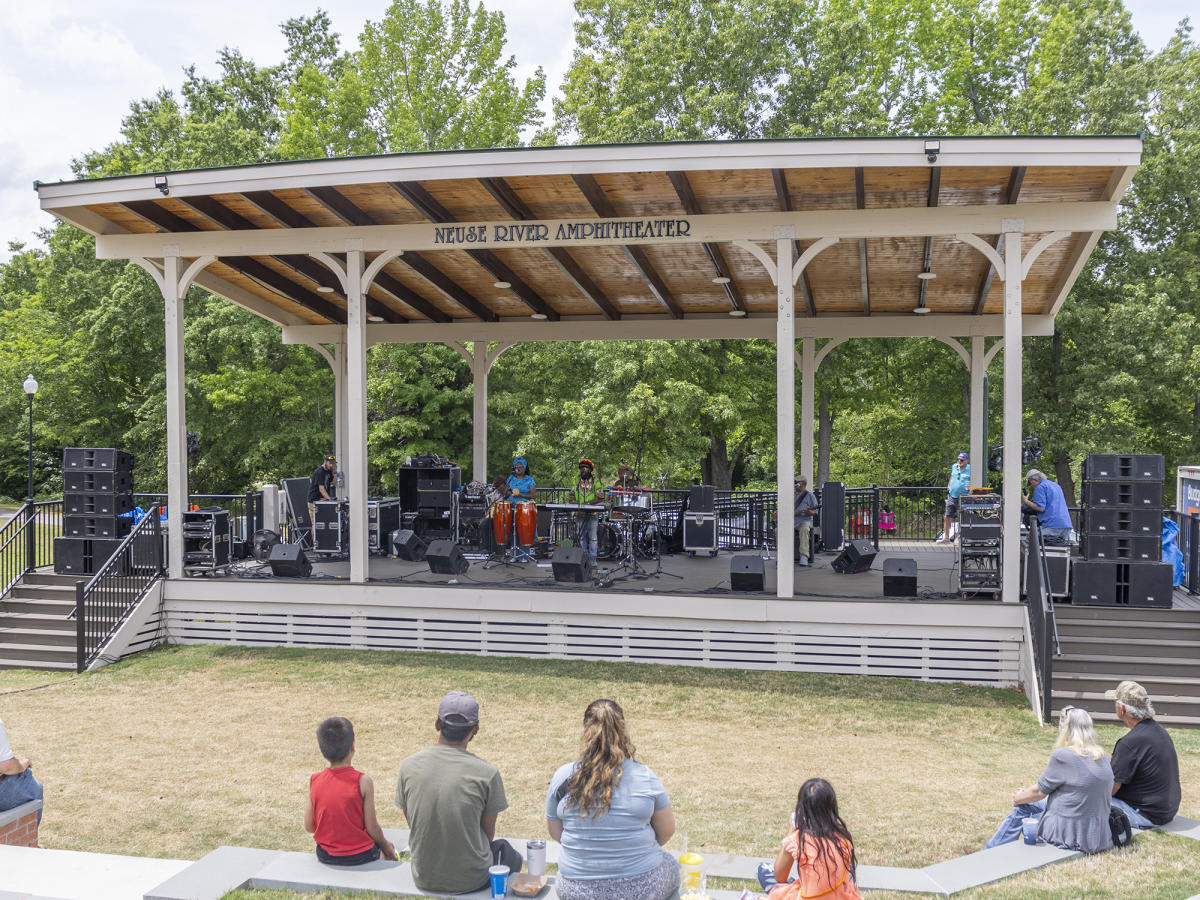 A crowd watches a Jamaican band play at the Neuse River Amphitheater during the Ham & Yam Festival.