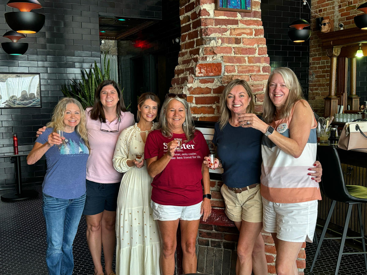 Group of Patrons stand and toast in Quantum Toad