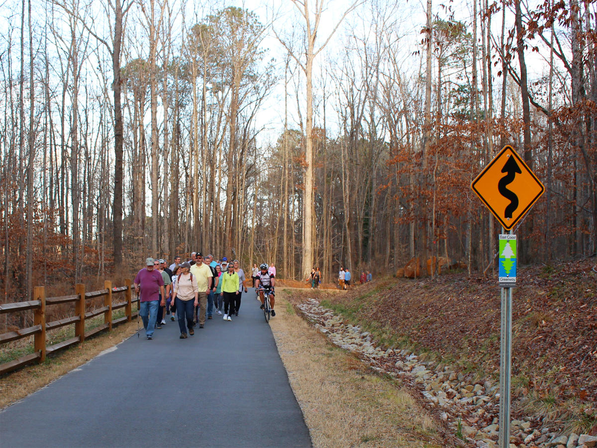 A group of people walking on the Sam's Branch Greenway during a 2022 event.
