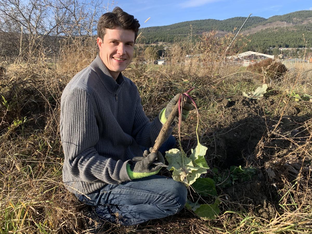 Scott Moran holds up a burdock root