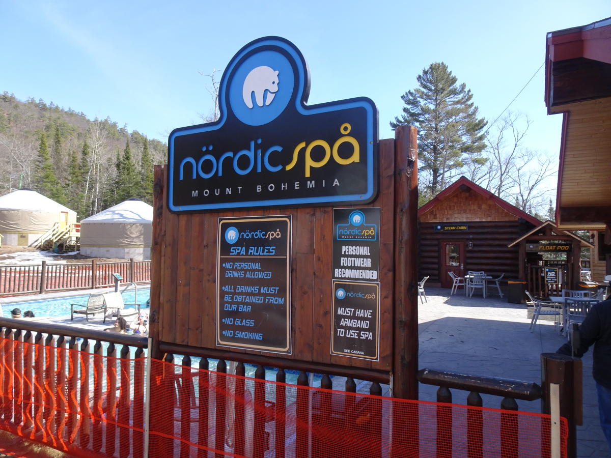a sign in front of an outdoor pool