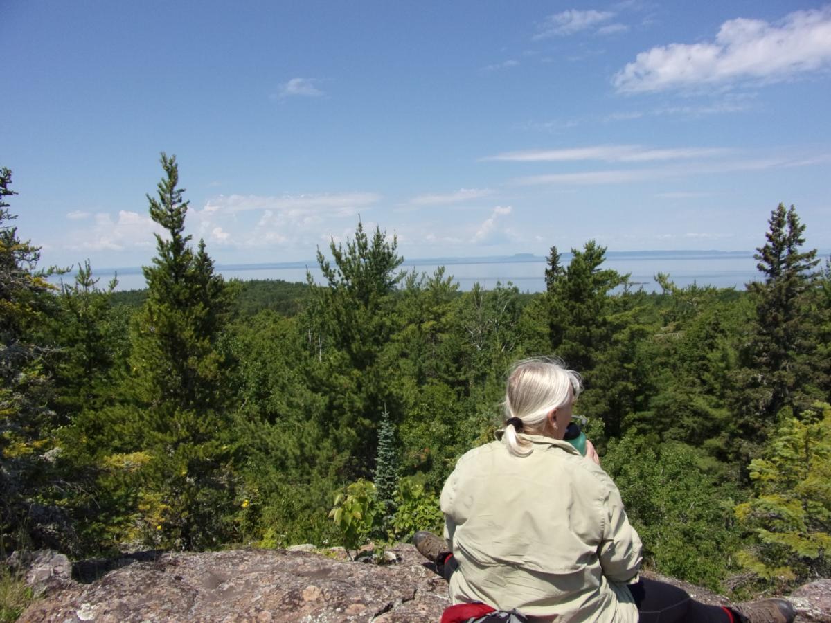 Wise Old Man of Isle Royale - Lady sitting on cliff