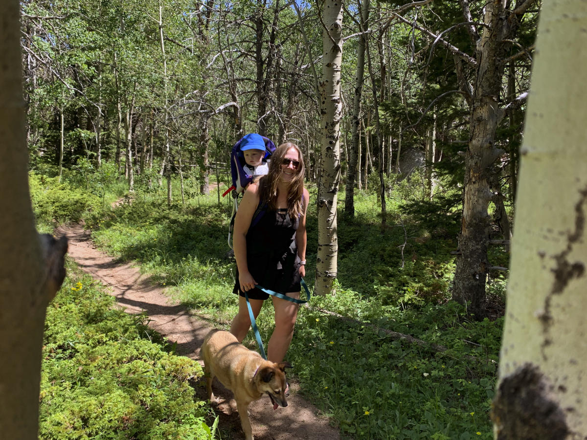 Mom and toddler hiking with a dog