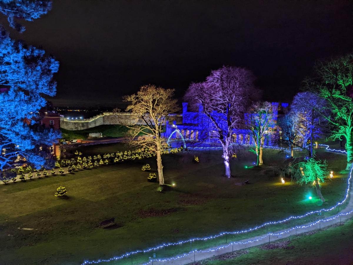 An image of the lawn of Lincoln castle with illuminated trees