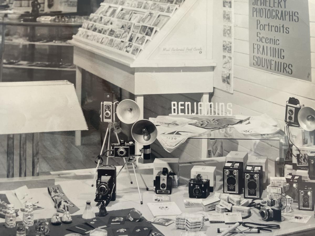 Black and white image of storefront display of cameras and other photography supplies at Benjamin Kodak on Mackinac Island