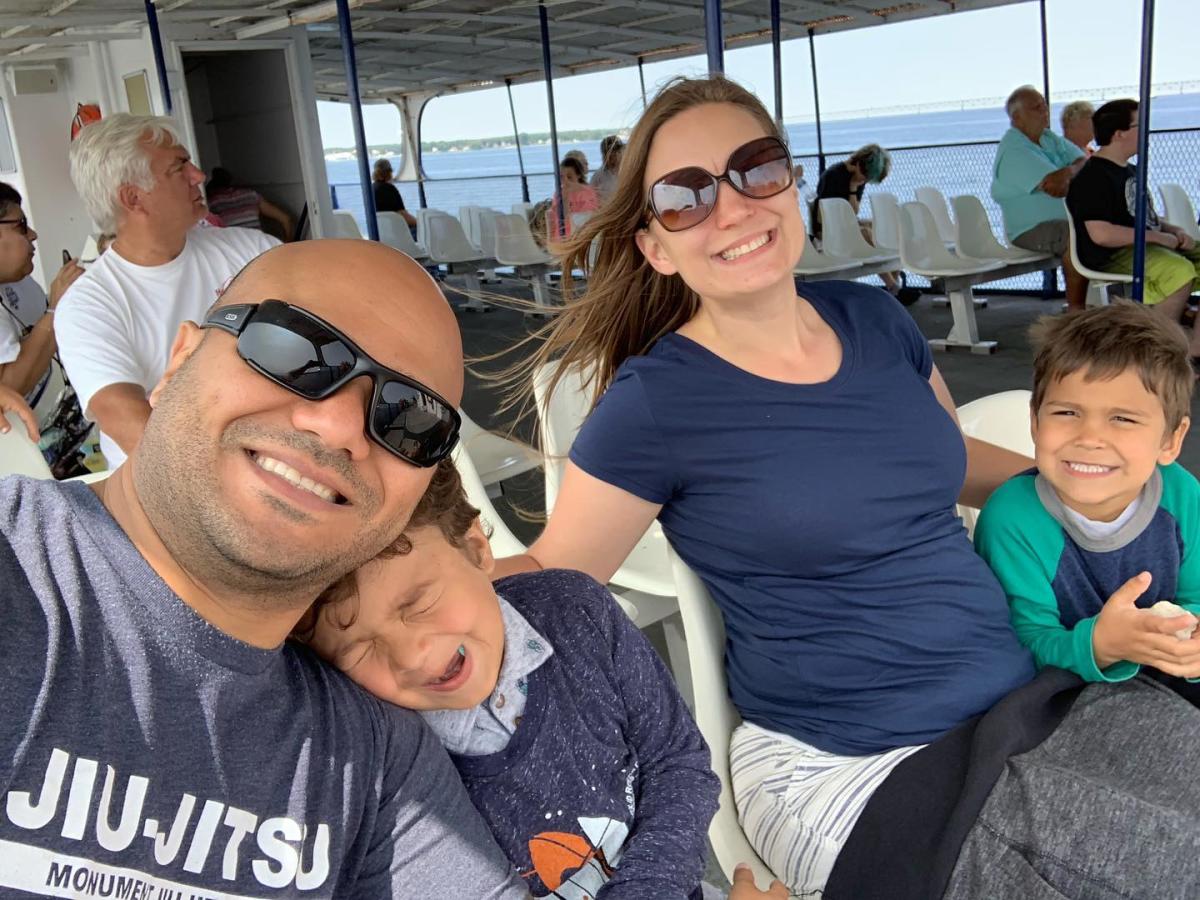 Family of four in open-air seating of a Mackinac Island ferry boat