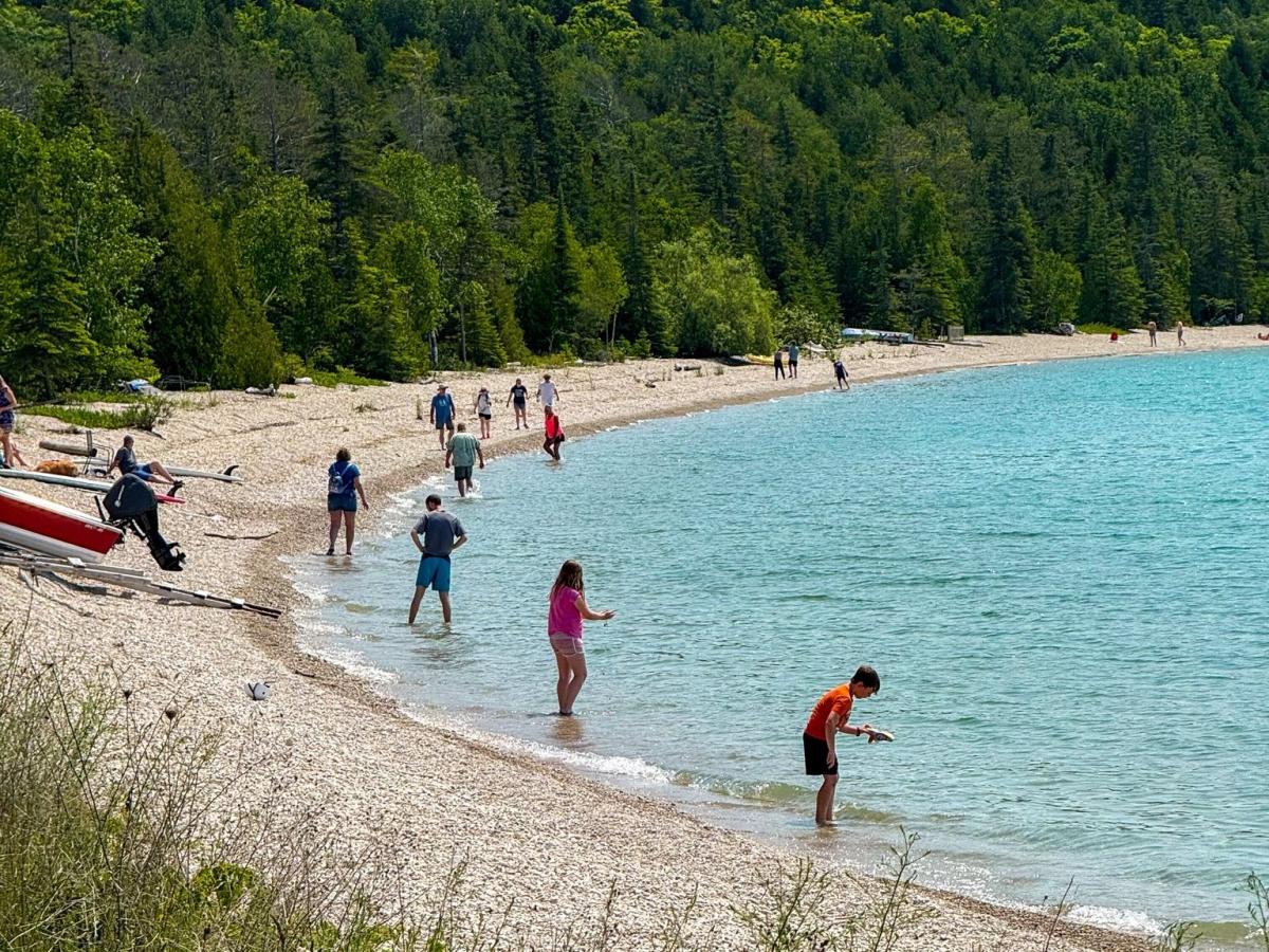 People line the rocky shore of Mackinac Island while setting a Waboba ball relay world record.