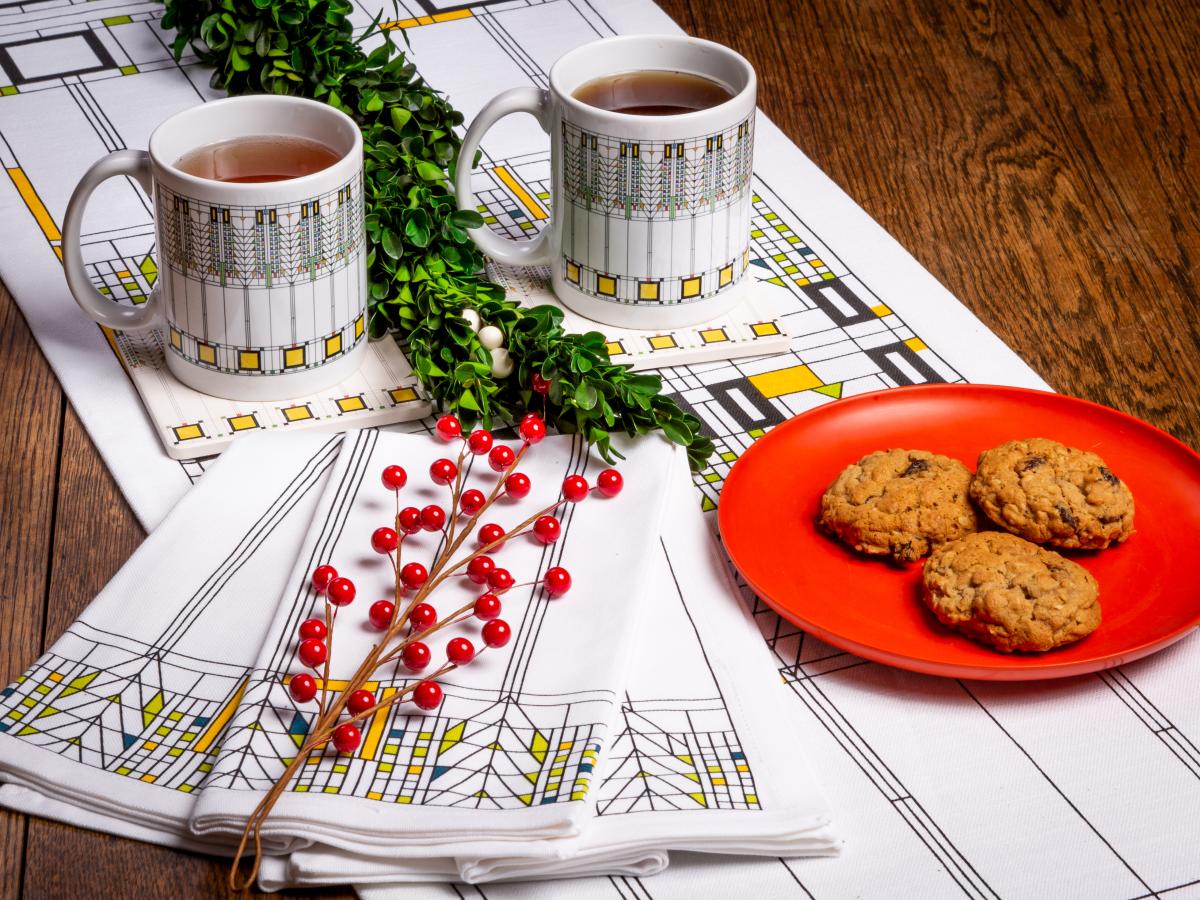 Mugs of coffee and cookies sit out on a decorative table setting courtesy of Taliesin