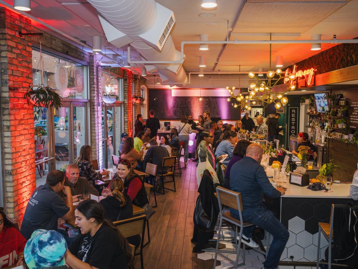 Interior shot of a packed dining hall at Crossroads Collective