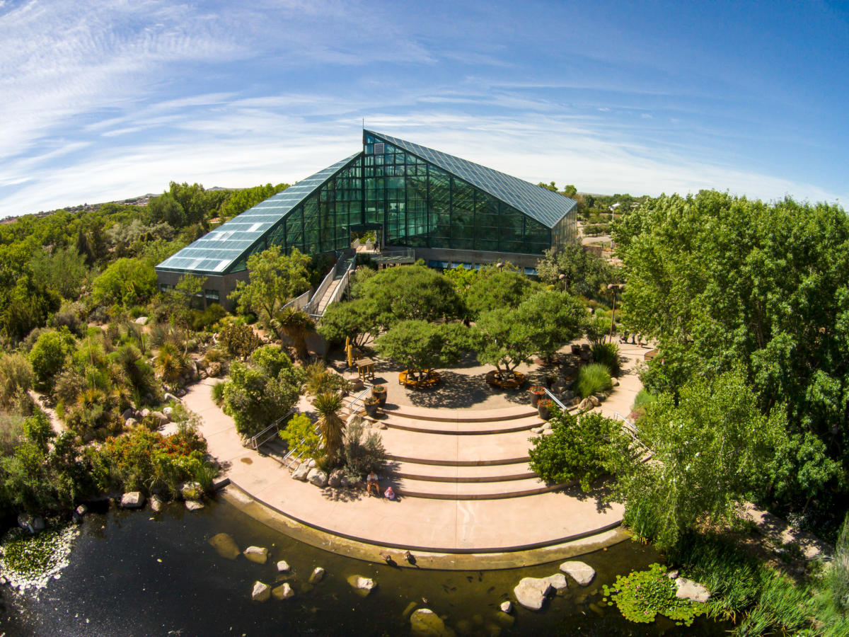 Aerial view of the Botanic Garden glasshouse with surrounding greenery and outdoor seating areas.