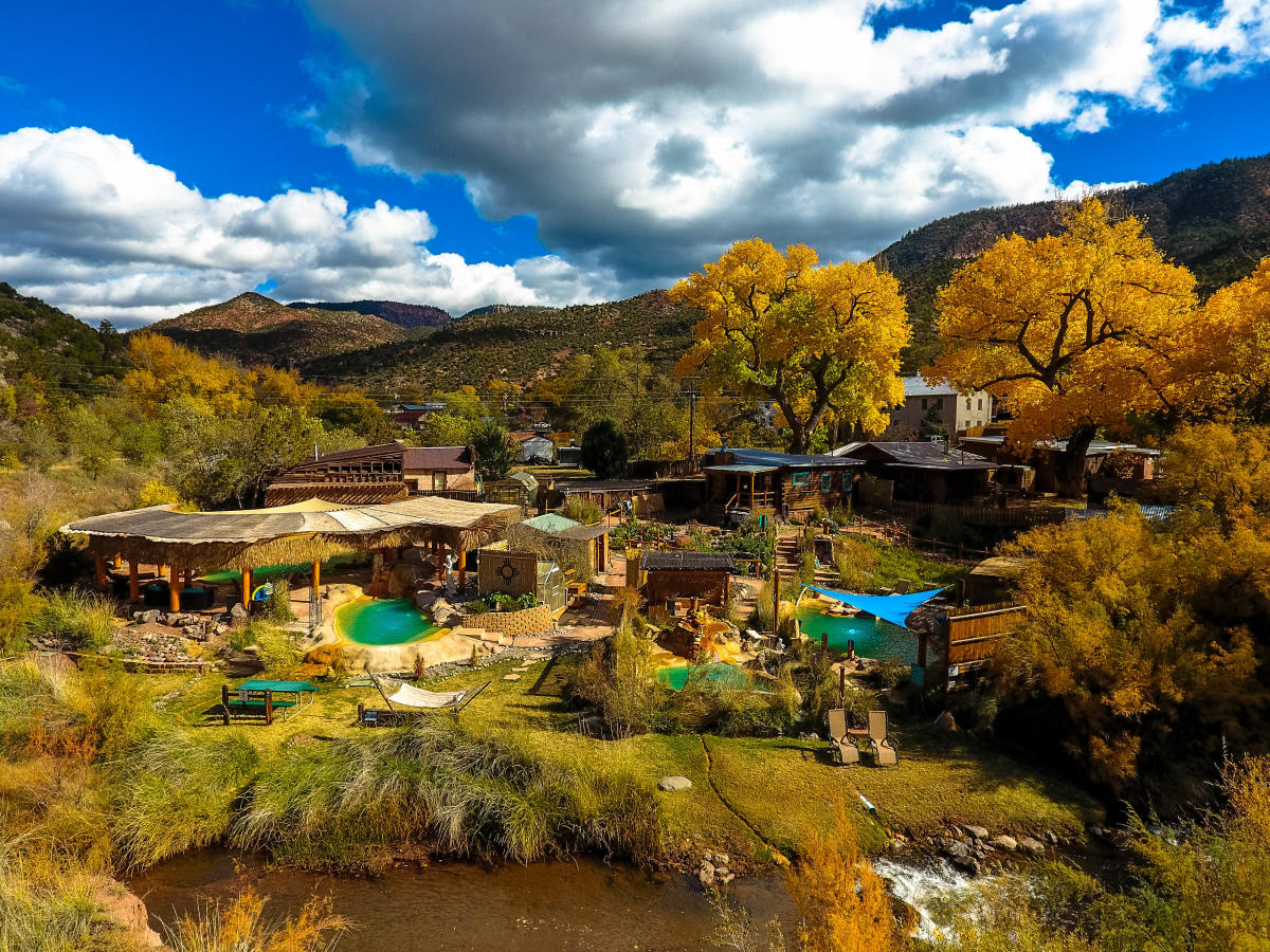 Jemez Hot Springs offers golden leaves against red cliffs.