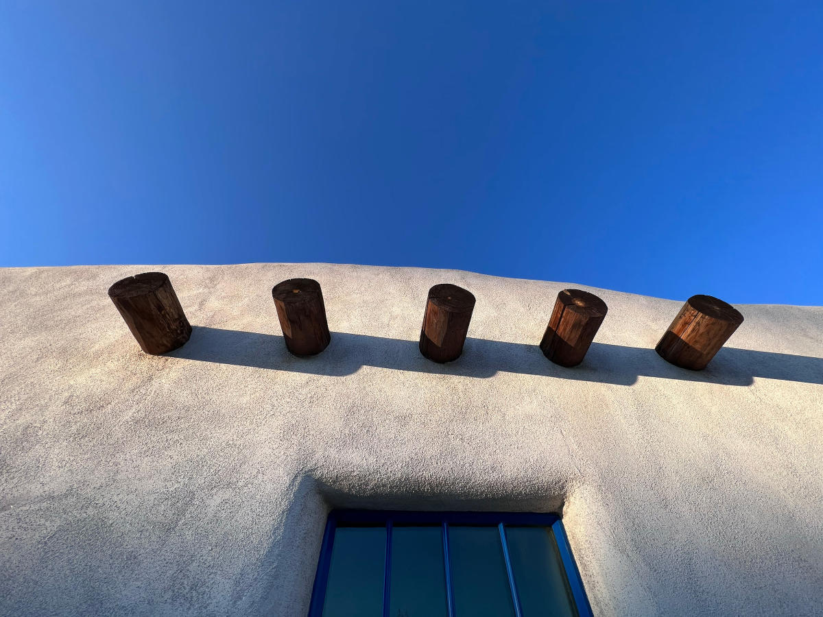 3rd place winner in the Mobile category of the 23rd Annual Photo Contest features a white adobe building with exposed vigas.