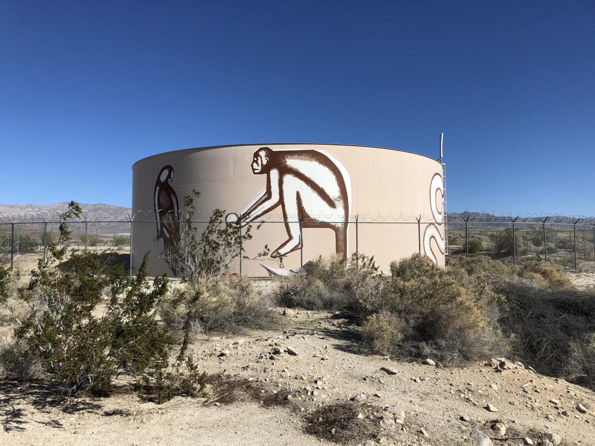 A 32-foot tall water tank in Coachella with a mural painted on it called "Visit Us in the Shape of Clouds” by Armando Lerma.