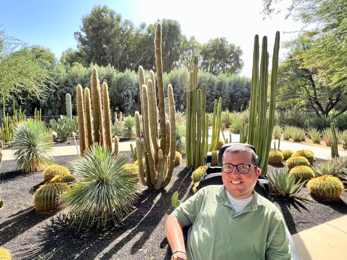 Man in wheelchair smiling as he visits Sunnylands garden