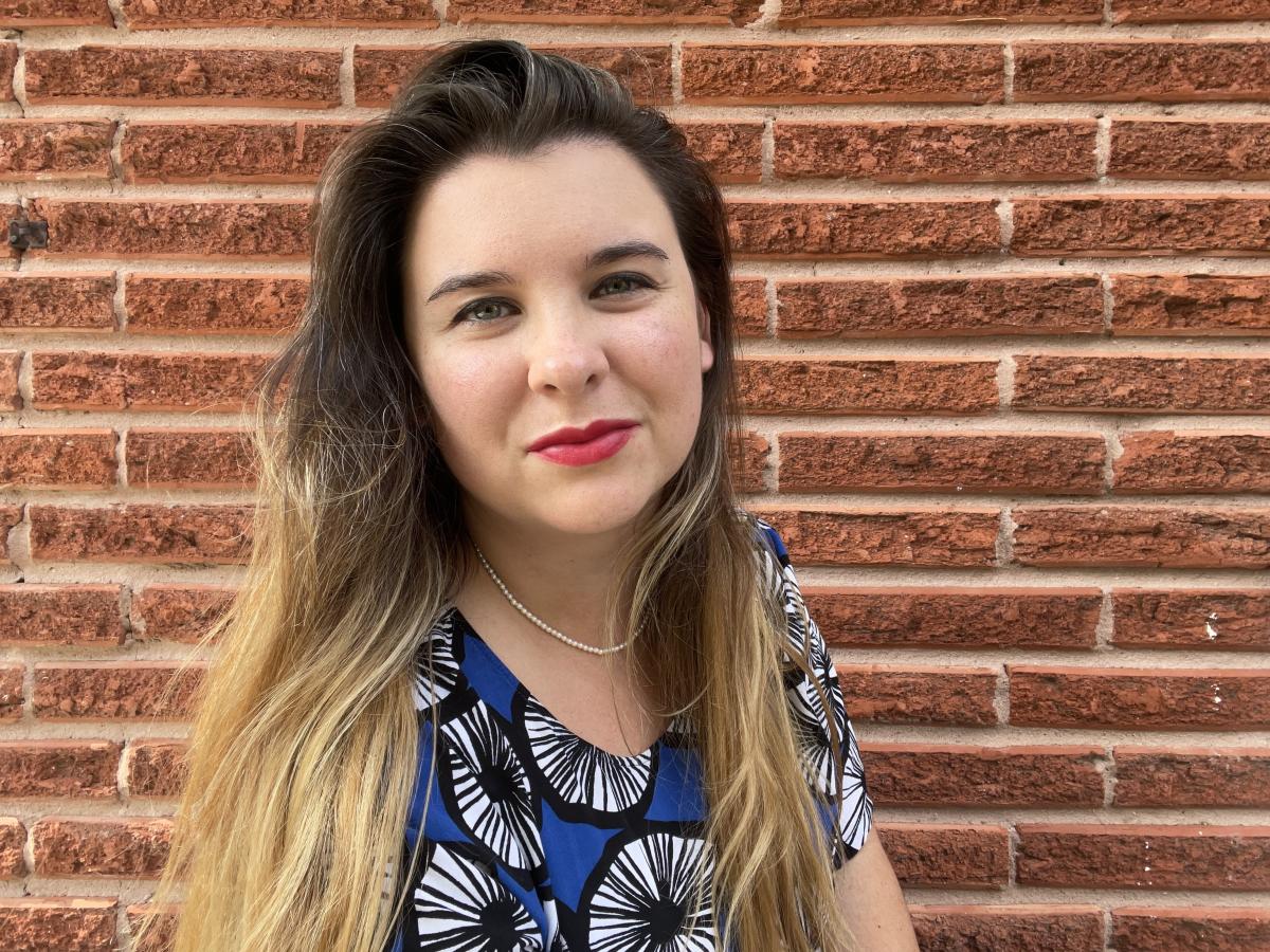 Headshot of Emma Balter posing against a brick wall