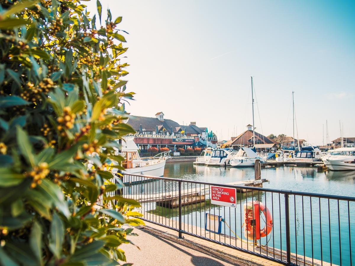 Photograph showing the tranquil marina at Port Solent, with boats and restaurants in the background.