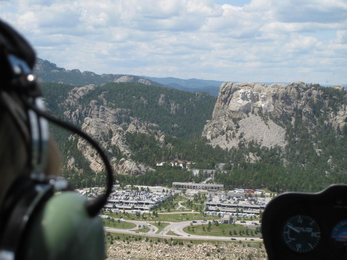 Looking out the windshield of a helicopter at mount rushmore national memorial