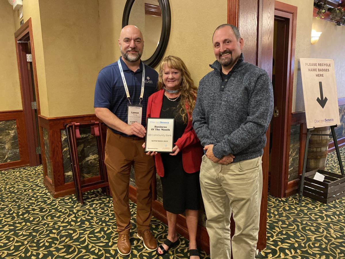 Diane Janes of Community Bank presented with the September 2023 Business of the Month Award Plaque by del Lago representative Lance Young and Seneca Meadows representative Mark Benjamin at the September Business After Hours event at Ciccino's Restaurant