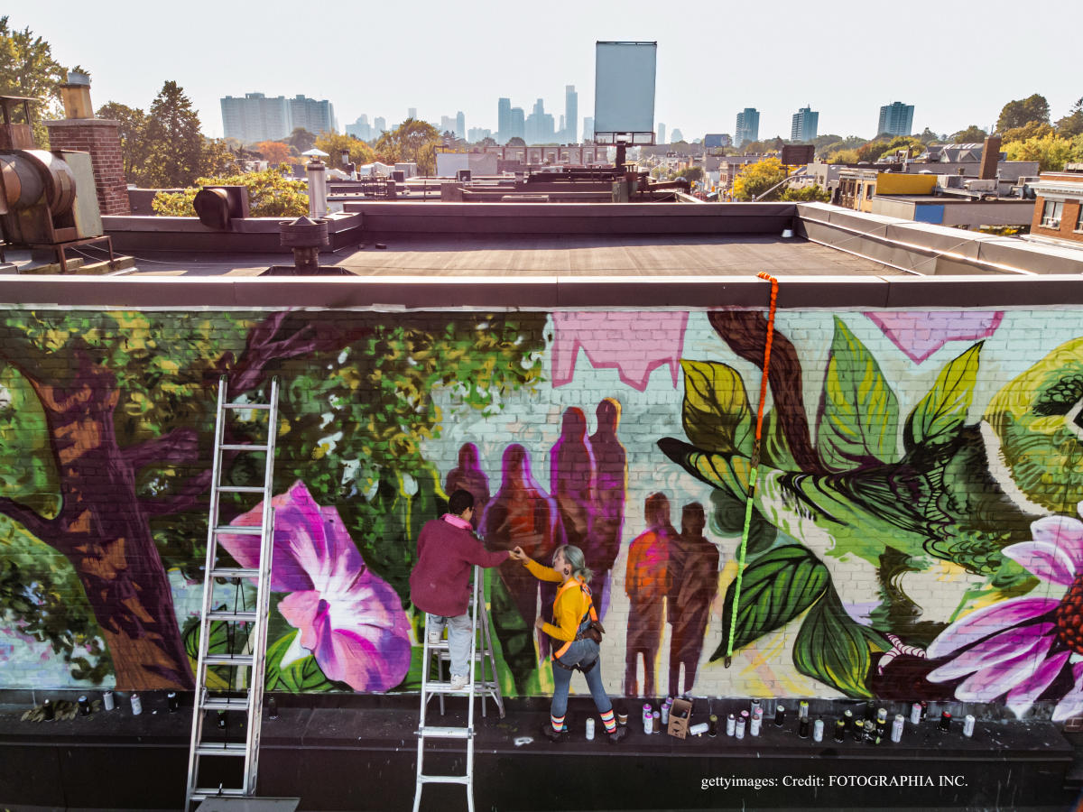 Artists working on graffiti mural in Toronto, Canada