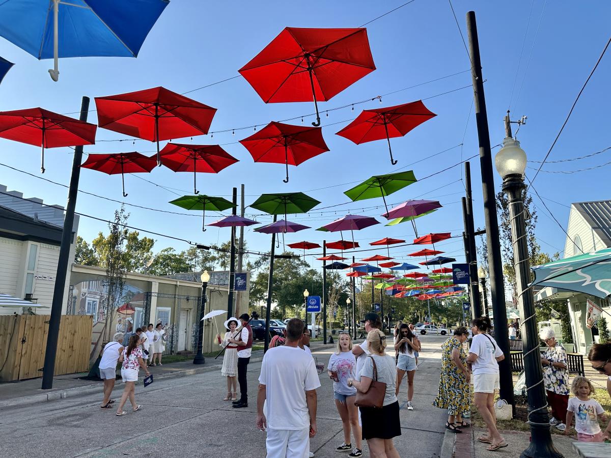 Strolling Antique Umbrella Alley at Olde Towne Slidell's annual August event, White Linen and Lagniappe