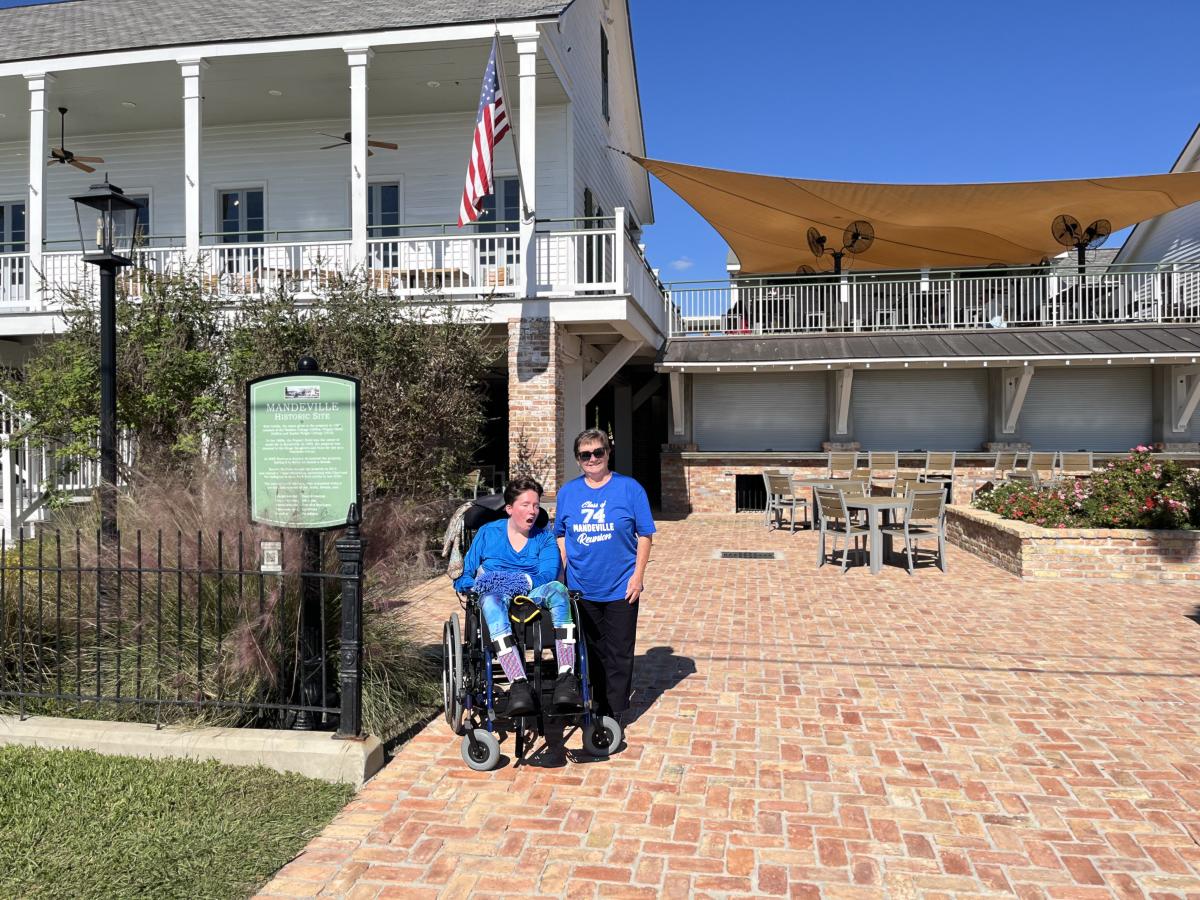 Christy and PJ with the historic marker sign in front of Pat's Rest Awhile on the city's self-guided accessible QR code tour.