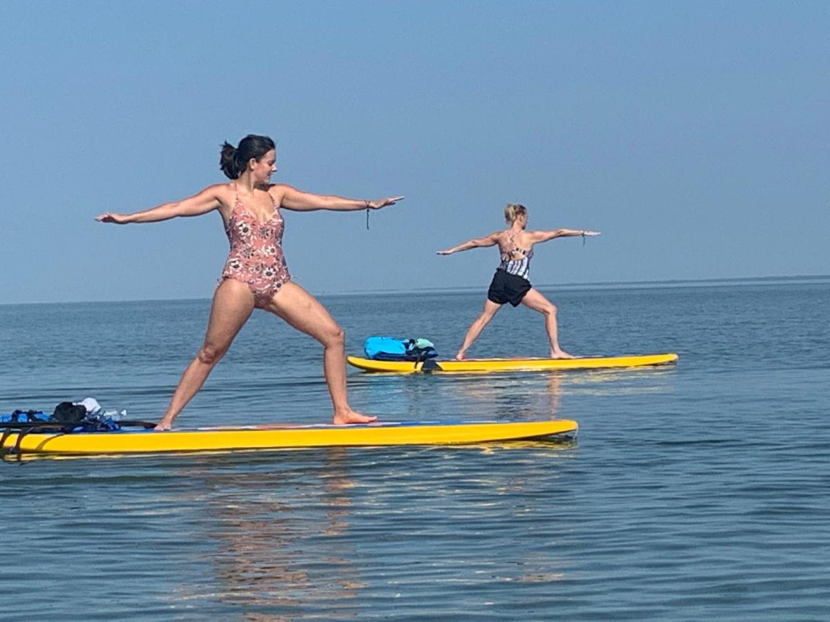 Practice yoga on a paddleboard with Cypress SUP Yoga and Paddleboard Co.