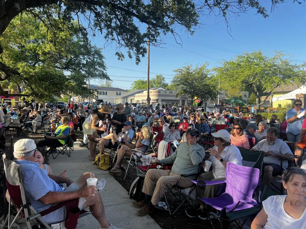 Concert-goers in festival chairs line the sidewalk and streets around the Covington Trailhead for a Rockin' the Rails concert.