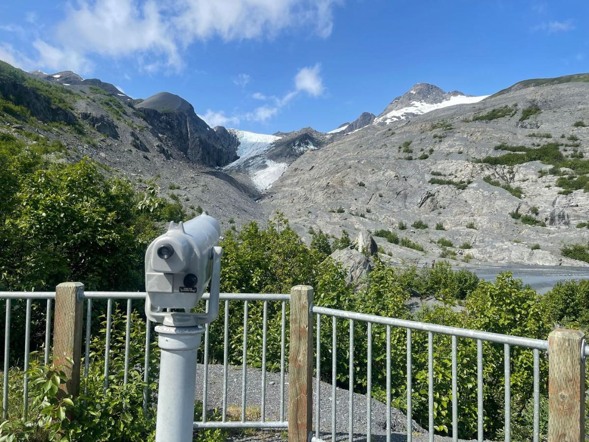 A telescope in a state park focused on an alpine glacier