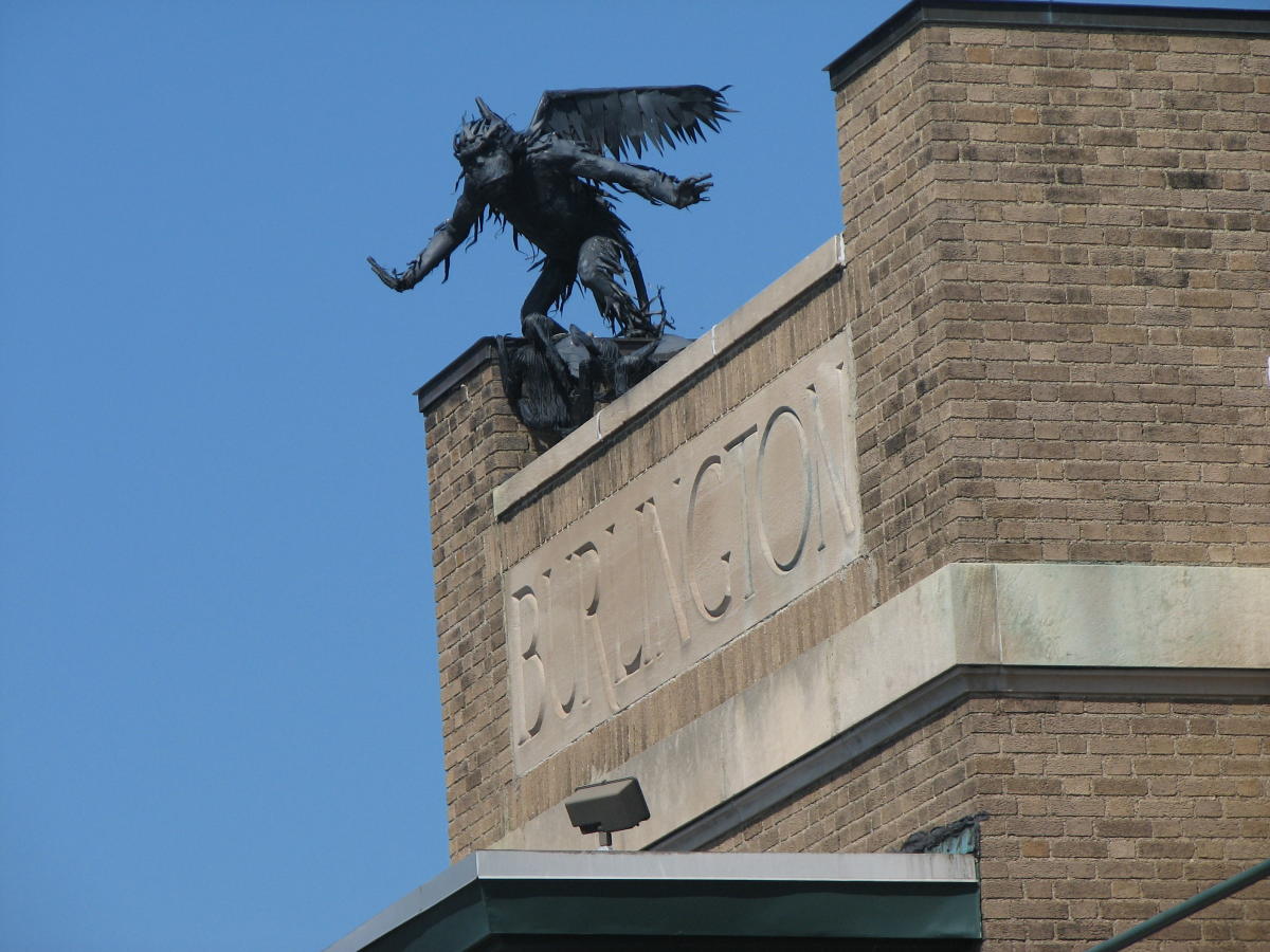 Photo of the Flying Monkey statues perched on top of One Main Street looking over Burlington