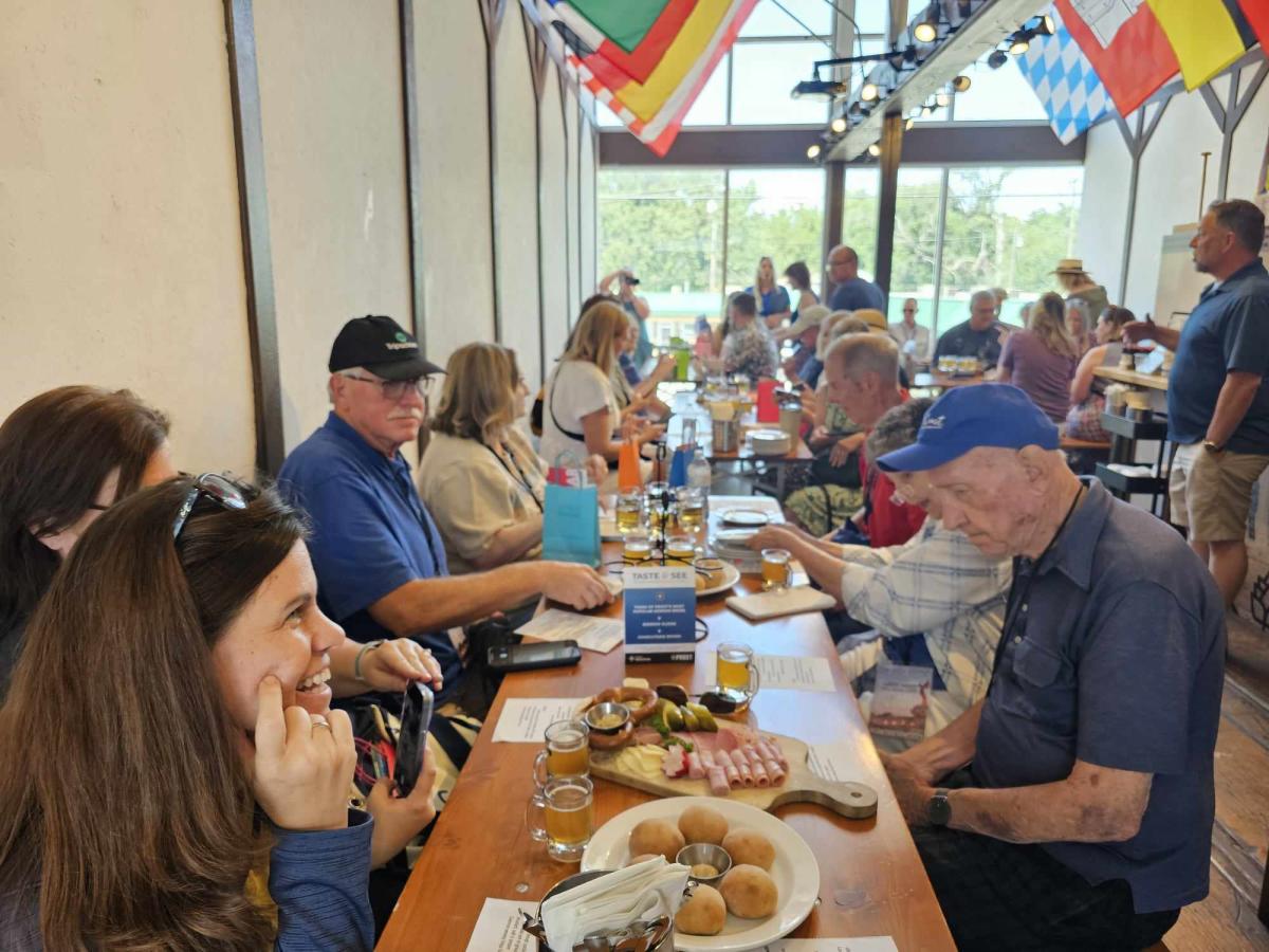 A group of people enjoy German food at Prost