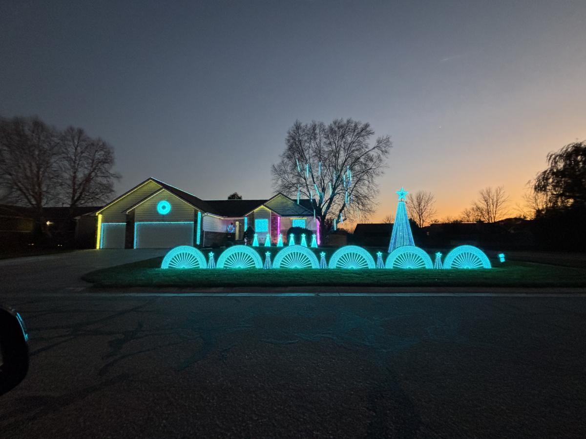 Lights illuminate a home and front yard in Wichita