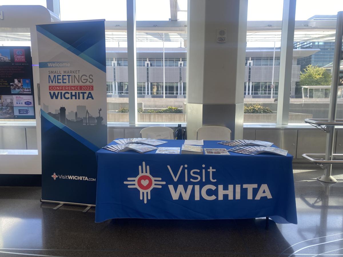 A table is set up to welcome people at the airport who are coming for a meeting
