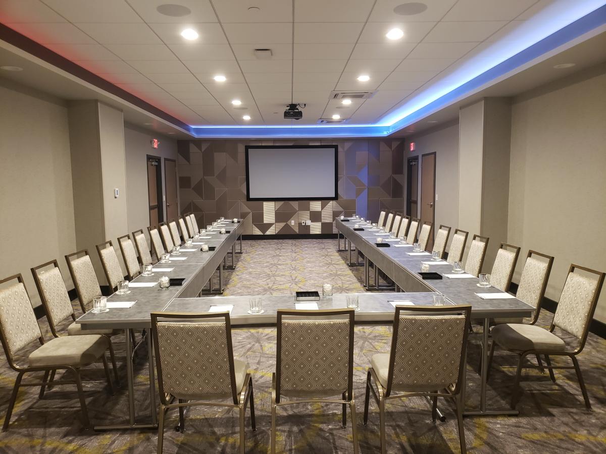 Chairs are set up around rectangular tables inside the boardroom at Hilton Garden Inn Downtown