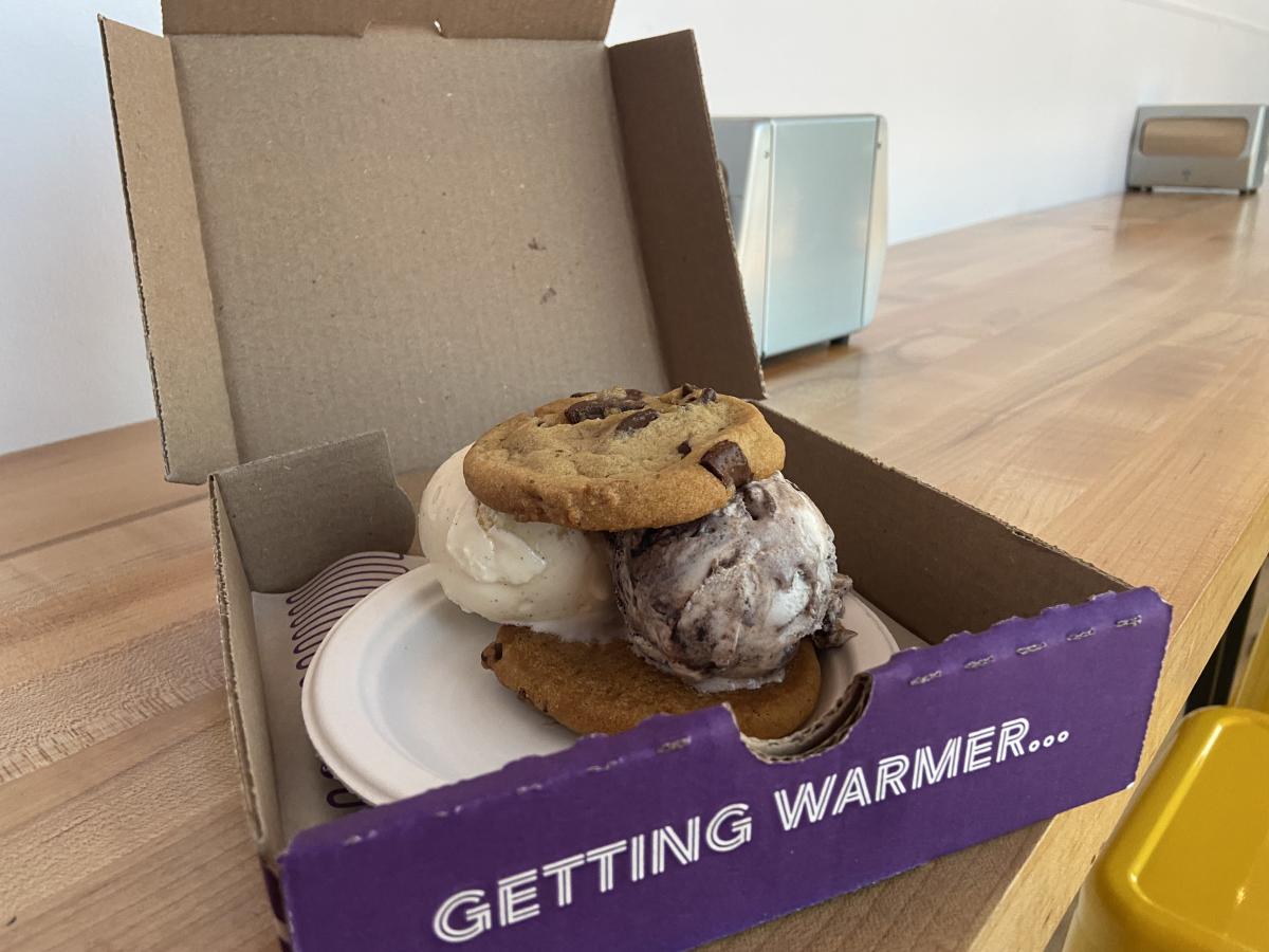 Two cookies are served with two scoops of ice cream in the middle at Insomnia Cookies