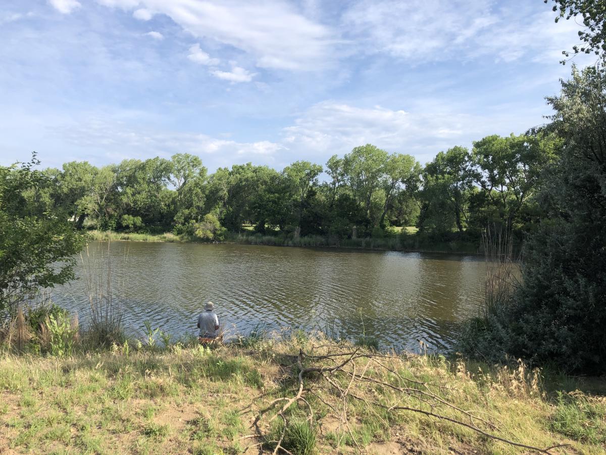 A man fishes at a pond located in Sedgwick County Park