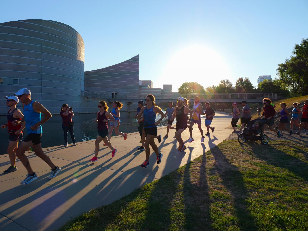 Men and women run past Exploration Place during the Parkrun event
