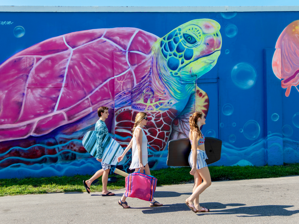 Family walking past Carolina Beach Mural Marine Magic