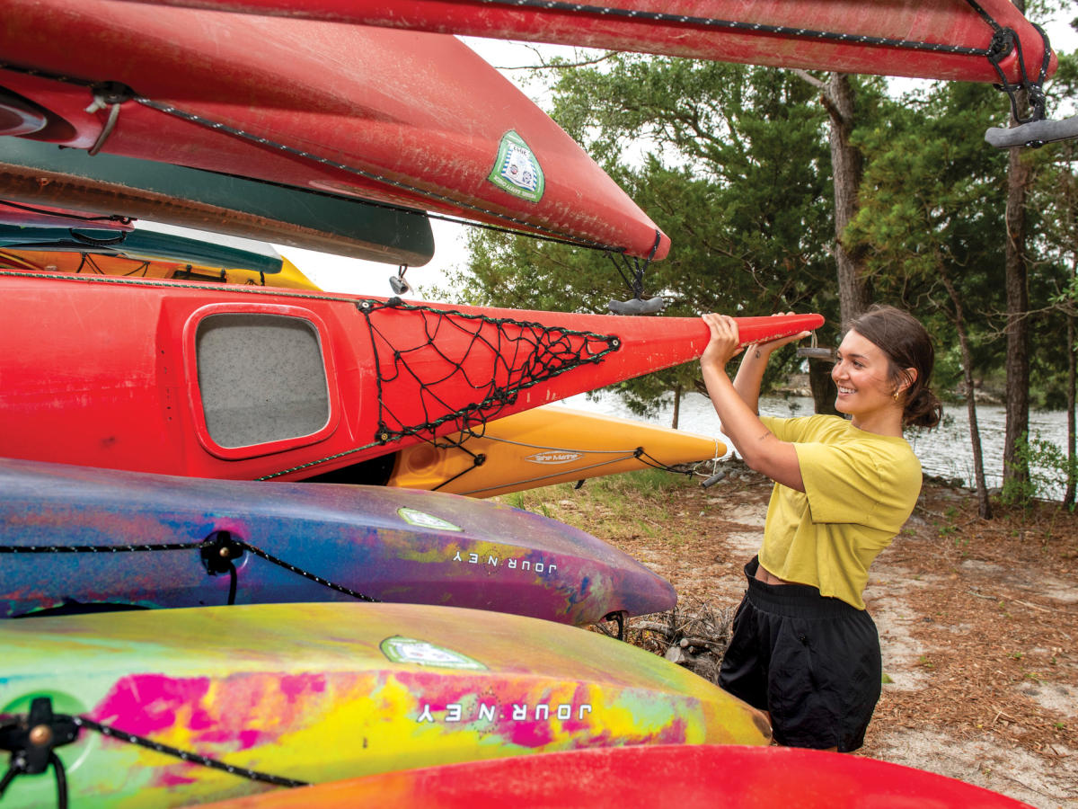 Woman with Kayaks at Paddle NC at the Carolina Beach State Park