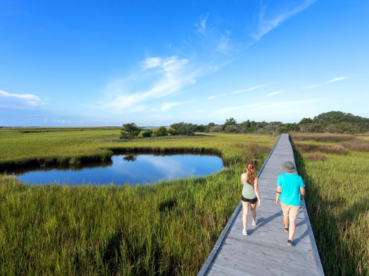 Couple hiking at Basin Trail at Fort Fisher State Recreation Area in Kure Beach