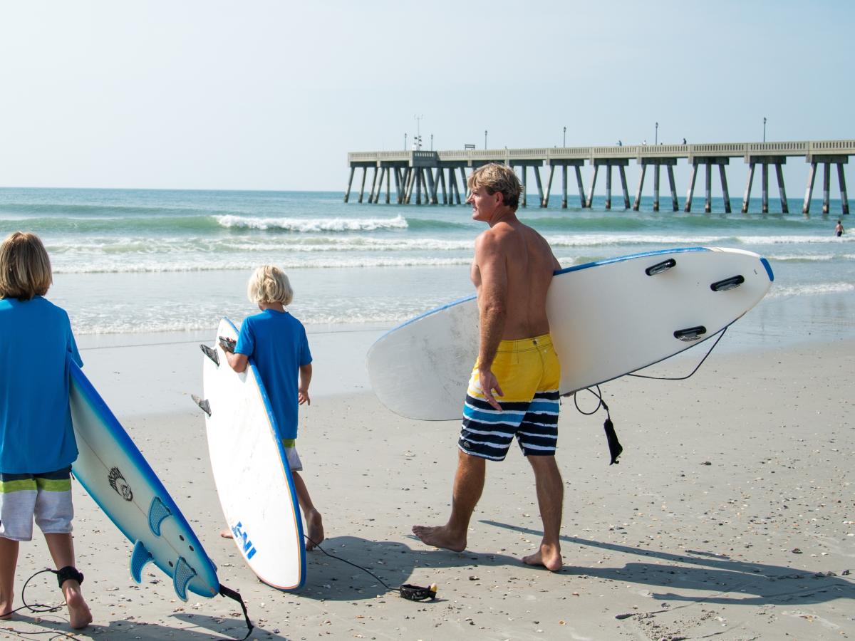 Family surfing on Wrightsville Beach