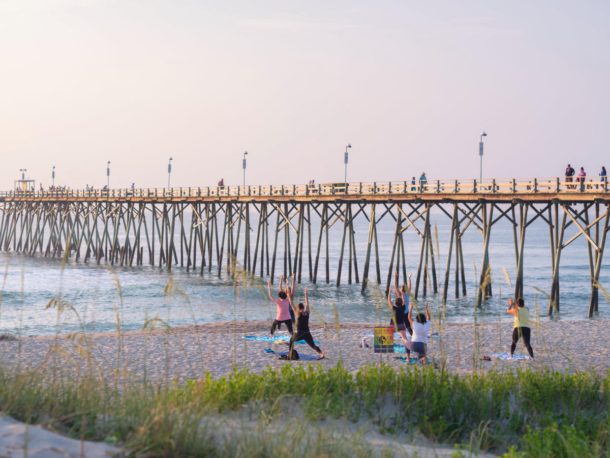 People doing yoga at Kure Beach