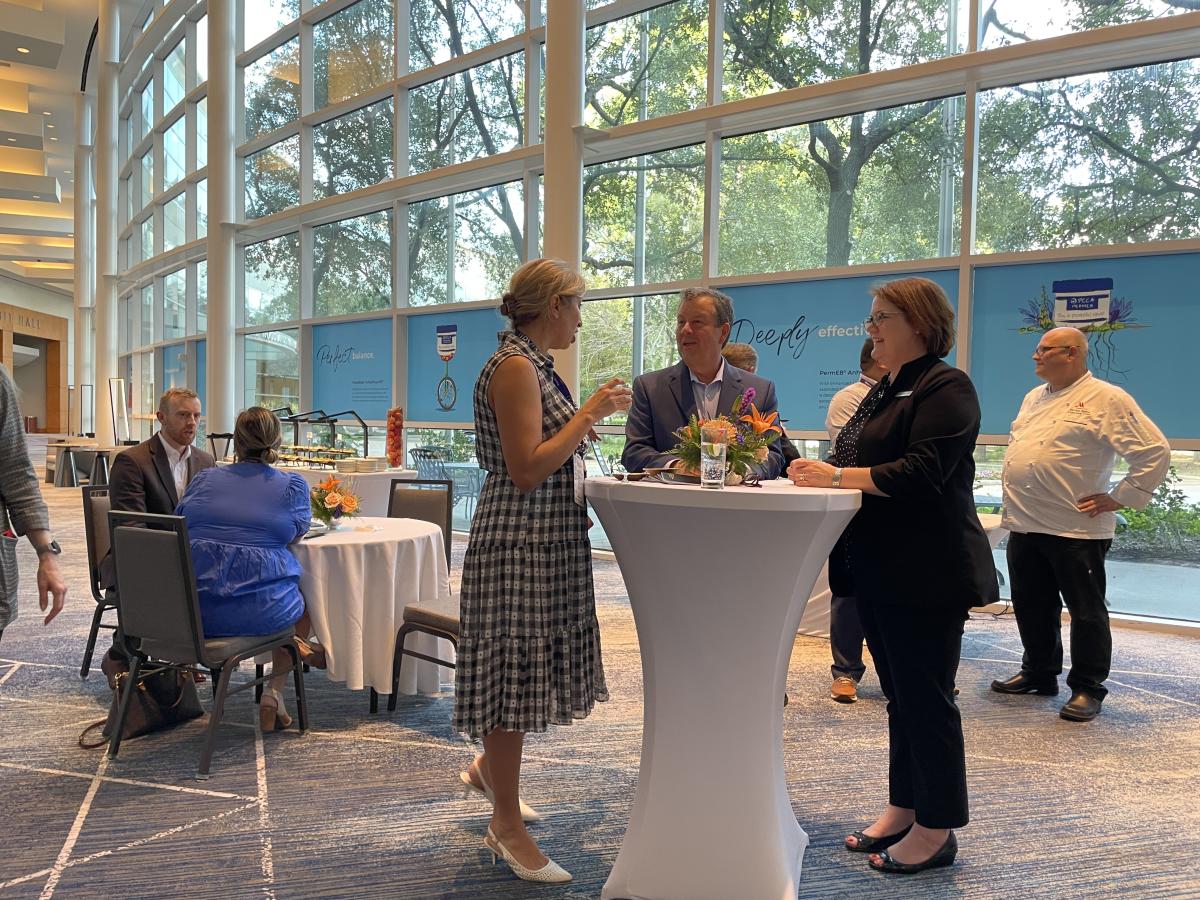 Jennifer Gohagan and Nick Wolda mingling at The Woodlands Waterway Marriott during Connect Texas