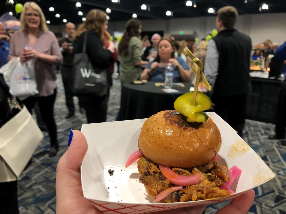 Person holding tiny burger at Taste of the Town in The Woodlands Texas