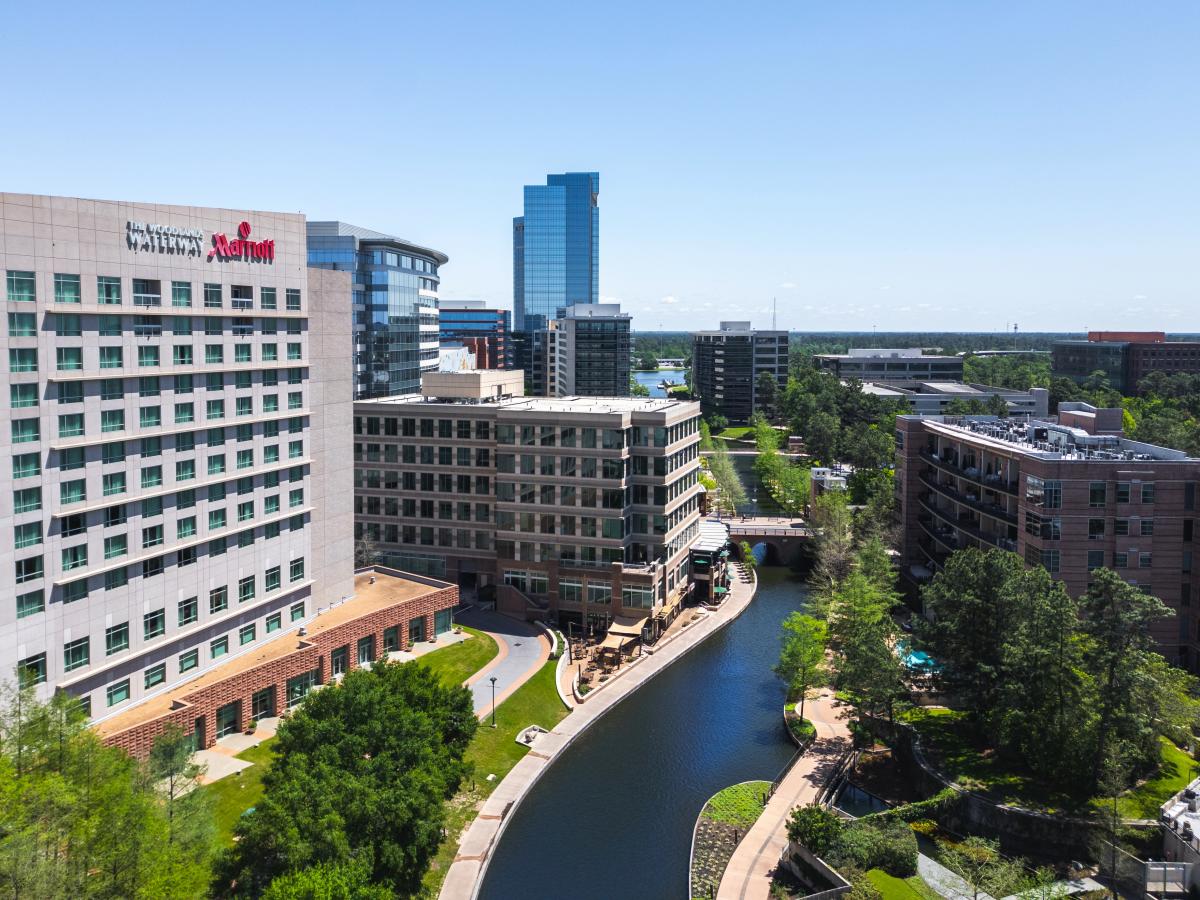 An overhead view of The Waterway Marriott and The Waterway on a bright cloudless day.