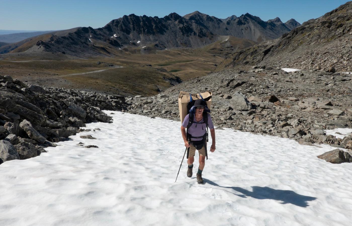 Volunteer Carrying Predator Traps at The Remarkables